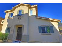 Charming two-story home with a stucco exterior, complemented by green shutters and a terra cotta tile roof at 14861 W Ashland Ave, Goodyear, AZ 85395