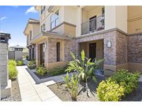 Charming townhome exterior with brick accents, lush landscaping, and inviting walkways create curb appeal at 17850 N 68Th St # 1017, Phoenix, AZ 85054