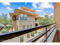 Stunning multi-story condo with large windows and mature landscaping viewed from balcony at 20100 N 78Th Pl # 2019, Scottsdale, AZ 85255