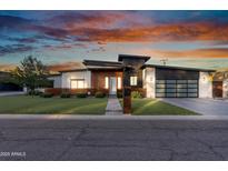 Stunning modern home featuring unique architectural details, wood accents, and a stylish three-car garage at 2215 N 38Th Way, Phoenix, AZ 85008