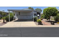 Charming mobile home features a covered carport and beautifully landscaped surroundings at 2233 E Behrend Dr # 17, Phoenix, AZ 85024
