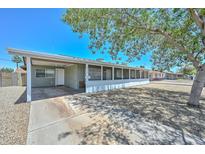 Charming single-story home with a covered carport, a screened porch, and low-maintenance landscaping at 2922 W Citrus Way, Phoenix, AZ 85017