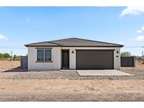 Charming single-story home featuring a neutral stucco finish, a gray garage door, and desert landscaping at 3105 W Romana Dr, Eloy, AZ 85131