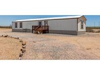 Charming mobile home with a quaint porch and neutral color palette, perfect for simple living at 48773 Cerezo Rd # 20, Maricopa, AZ 85139