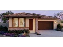 Charming single-story home featuring a two-car garage and beautifully landscaped front yard at 5597 S 253Rd Ave, Buckeye, AZ 85326