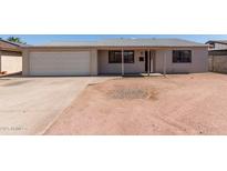Charming single-story home with a classic garage, covered porch, and desert-style landscaping at 5807 W Encanto Blvd, Phoenix, AZ 85035