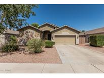 Charming single-Gathering home with a two-car garage, desert landscaping, and well-manicured shrubs at 609 S 122Nd Dr, Avondale, AZ 85323