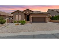 Charming single-story home features a tile roof, stone accents and a two car garage at 6936 E Snowdon St, Mesa, AZ 85207
