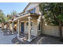 Charming two-story home featuring a welcoming front porch and neutral color palette at 813 E Agua Fria Ln, Avondale, AZ 85323