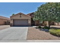 Charming single-story home featuring a two-car garage and desert landscaping at 9437 W Georgia Ave, Glendale, AZ 85305
