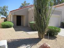 Charming single-story home with desert landscaping and a well-maintained front yard at 1450 E Laurel Ave, Gilbert, AZ 85234