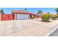 Charming single story home featuring a well-kept front yard and a two-car garage at 2324 E Crescent Ave, Mesa, AZ 85204
