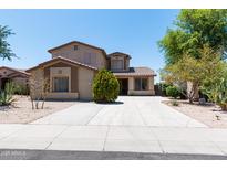 Charming two-story home featuring a well-maintained front yard and long driveway at 2527 E Remington Pl, Chandler, AZ 85286