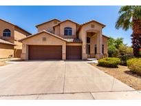 Two story home with a large driveway, three car garage, and desert landscaping at 2741 E San Tan St, Chandler, AZ 85225