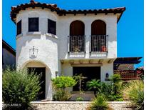 Charming stucco home with balconies and a tile roof, complemented by a well-maintained front yard and desert landscaping at 2944 N Brighton --, Mesa, AZ 85207