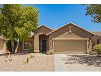 Charming single-story home featuring desert landscaping, a two-car garage, and a welcoming front entrance at 29919 N Little Leaf Dr, San Tan Valley, AZ 85143