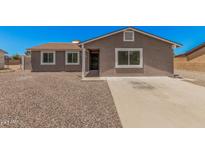 Charming single-story home featuring a desert landscape, concrete driveway, and neutral paint scheme at 3056 N 68Th Ln, Phoenix, AZ 85033