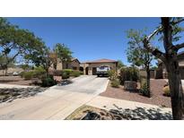Beautiful single-story home featuring desert landscaping, a red tile roof, and a long driveway at 3063 N Heritage St, Buckeye, AZ 85396