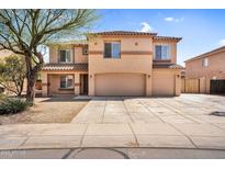 Two-story home featuring a three-car garage and a desert-landscaped front yard under a sunny blue sky at 3423 E Superior Rd, San Tan Valley, AZ 85143