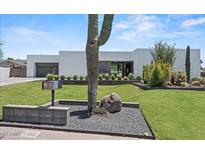 Contemporary home showcasing a well-maintained lawn and desert landscaping at 5301 N 43Rd St, Phoenix, AZ 85018