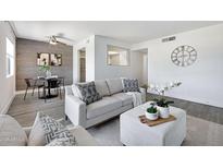 Modern living room with stylish furniture, gray flooring, and decorative accents at 616 S Hardy Dr # 203, Tempe, AZ 85281