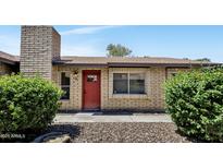 Charming single-story home with a red front door, brick facade, and well-maintained landscaping at 6415 S Newberry Rd # A, Tempe, AZ 85283