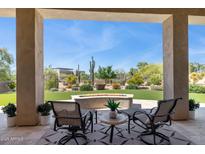 Inviting back patio with comfortable seating and a cozy fire pit, perfect for outdoor relaxation at 6450 E Monterra Way, Scottsdale, AZ 85266