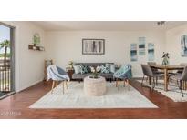This is a living room and dining room combo with wood floors, a decorative rug, and neutral decor at 740 W Elm St # 266, Phoenix, AZ 85013