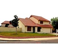 Charming home with a well-manicured front yard and a classic tile roof at 7537 W Dreyfus Dr, Peoria, AZ 85381