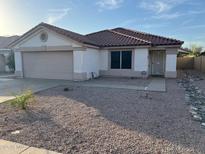 Charming single-story home featuring a tile roof, stucco siding, and low maintenance desert landscaping at 8254 E Posada Ave, Mesa, AZ 85212