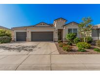 Charming single-Gathering home features a neutral exterior, well-maintained landscaping, and a spacious three-car garage at 1284 W Sussex St, San Tan Valley, AZ 85143