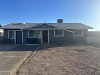 Cozy single-story home features a light-grey facade, classic lines, and low maintenance desert landscaping at 2019 E Southern Ave, Phoenix, AZ 85040