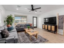 Inviting living room with gray sofas, decorative pillows, wooden coffee table and accent rug at 2041 W Palo Verde Dr, Phoenix, AZ 85015
