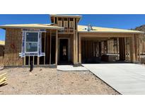 New home in the framing stage with a concrete driveway and two car garage at 27366 N 69Th Dr, Peoria, AZ 85383