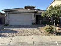 Charming single-story home with a well-manicured front yard and a two-car garage at 330 W Evergreen Pear Ave, Queen Creek, AZ 85140