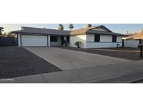Charming single-story home featuring a well-manicured front yard, long driveway, and an attached two-car garage at 3810 W Yucca St, Phoenix, AZ 85029
