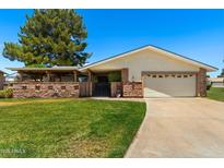 Charming single-story home featuring a well-manicured lawn, covered porch, and inviting curb appeal at 631 Leisure World --, Mesa, AZ 85206