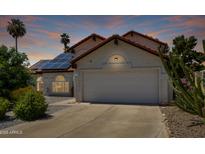 Charming single Gathering home with a two car garage, solar panels, and desert landscaping at 7108 W Morrow Dr, Glendale, AZ 85308