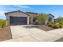 Charming single-story home with stone accents, a two-car garage, and a well-manicured front yard at 8027 W Northview Ave, Glendale, AZ 85303