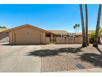 Charming single-story home with a desert landscape, neutral color palette, and two car garage at 961 Leisure World --, Mesa, AZ 85206
