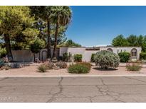 Charming home featuring desert landscaping, mature trees, and a decorative white fence at 1010 E Buena Vista Dr, Tempe, AZ 85284