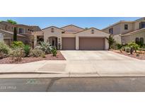 Charming single-story home with desert landscaping, a tile roof, and a spacious two-car garage at 10449 E Jacob Ave, Mesa, AZ 85209