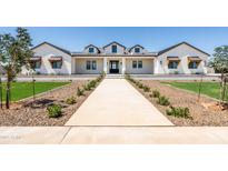 Stunning white modern farmhouse with a black roof, dormer windows and professional landscaping at 11564 E Windsor Way, Florence, AZ 85132