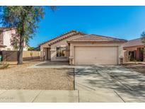 Charming single-story home with a well-maintained front yard and a two-car garage at 1447 E 12Th Pl, Casa Grande, AZ 85122