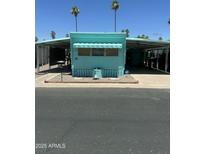 Charming turquoise mobile home with carport and small landscaped yard at 150 S Windsor Dr # 35, Mesa, AZ 85204