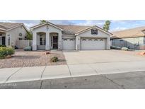Charming single-story home featuring a three-car garage and low maintenance desert landscaping at 1584 E Harrison E St, Chandler, AZ 85225