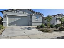 Charming single-story home featuring a neutral color scheme, well-maintained landscaping, and an attached two-car garage at 17423 W Country Club Ter, Surprise, AZ 85387