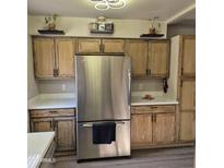 Bright kitchen featuring stainless steel appliances, light countertops, and warm wood cabinetry at 2946 N 14Th N St # 14, Phoenix, AZ 85014