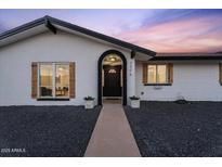 Charming single-story home with a welcoming front porch, manicured landscape, and a well-lit entrance at 3506 W Yucca St, Phoenix, AZ 85029