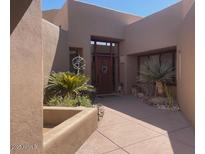 Inviting front entrance showcasing desert landscaping and a well-maintained walkway to the front door at 41576 N 107Th Way, Scottsdale, AZ 85262